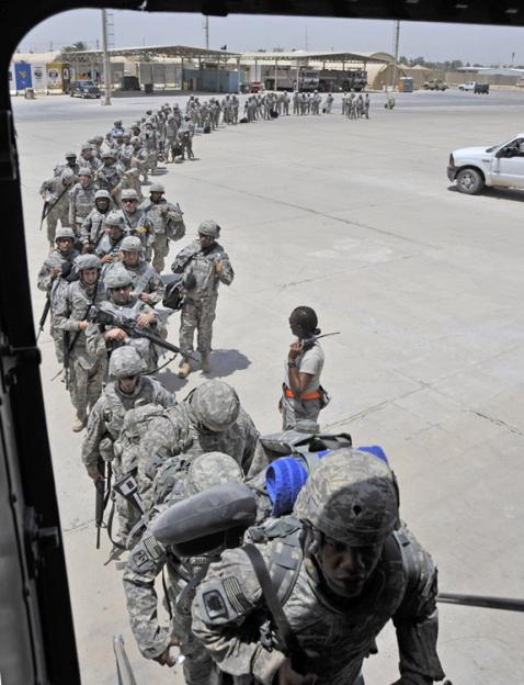 A battalion of U.S. soldiers boards a plane leaving Baghdad