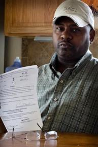A man in Nevada holds up part of the paperwork he has filed in an effort to secure his right to vote