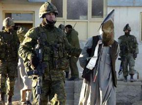 U.S. troops transport an Afghan detainee