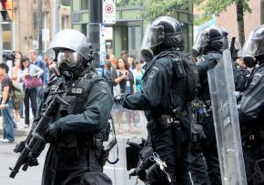 Riot police face down protesters outside the G20 Summit in Toronto