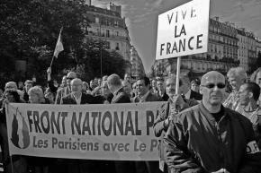 Jean-Marie Le Pen marches behind the banner of the National Front in Paris