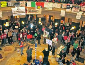 A crowd gathers in the Wisconsin Capitol rotunda to hear speakers talk on the people's mic