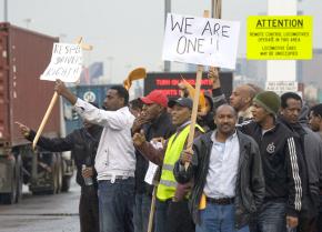 Striking truck drivers picket the Port of Seattle on February 8