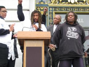 Fly Benzo speaking at a protest outside San Francisco's City Hall