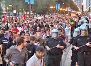Protesters march through the streets of Chicago to demonstrate their opposition to NATO's crimes