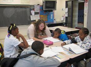 A teacher works with students in her fifth-grade class