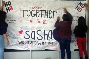 Students in Oakland sign a poster for Sasha
