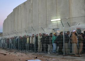 Palestinians caged in at an Israeli checkpoint in the West Bank
