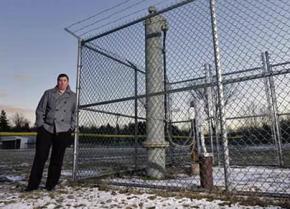 Michael Hickey stands next to the polluted municipal well in Hoosick Falls, New York