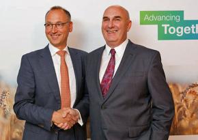 Bayer CEO Werner Baumann (left) greets his Monsanto counterpart Hugh Grant