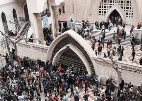 Worshippers fill the street outside a Coptic Christian church in Tanta after a deadly bomb attack