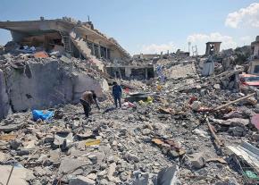 Civilians in Mosul search through the rubble left behind by a U.S. air strike