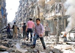 Civilians walk through the devastated streets of Raqqa