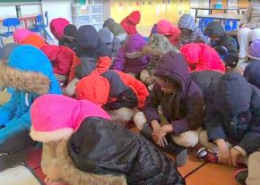 Children struggle to stay warm in an unheated classroom in Baltimore