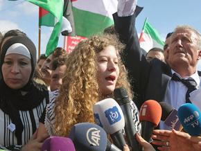 Ahed Tamimi (center) addresses supporters and the press after her release