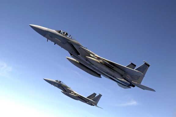 Two F-15 Eagle fighter jets perform a training exercise