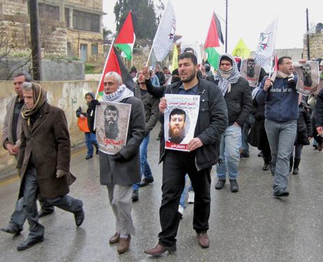 Protesters march through Nabi Saleh in solidarity with hunger striker Khader Adnan