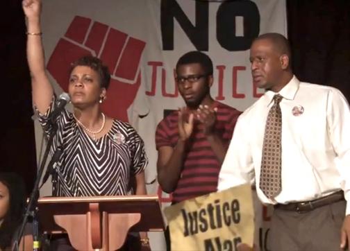 Jeralynn and Adam Blueford (at left and right) onstage at a Bay Area meeting against police violence