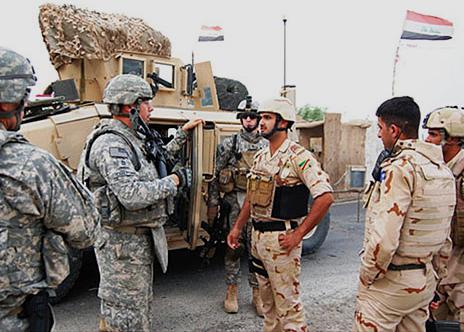 Iraqi officers talk to U.S. military advisors outside Mosul