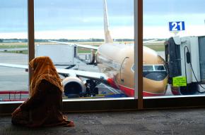 A Muslim woman prays in an airport