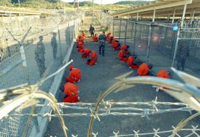 Detainees wait in a holding area at Guantánamo Bay's Camp X-Ray in 2002