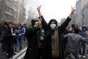 Iranian protesters flash a victory sign during demonstrations against President Mahmoud Ahmadinejad