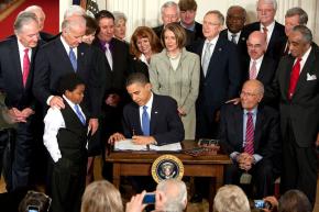 President Obama signs the new health care bill into law