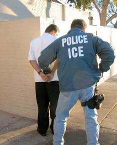 An ICE agent detains an undocumented worker