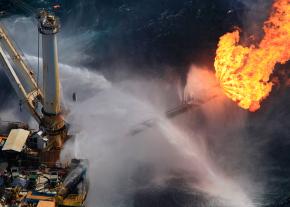 A giant flame roars off the side of a rig at the site of the Deepwater Horizon well