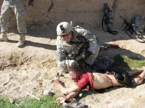 A U.S. soldier posing with an Afghan civilian murdered by members of his unit