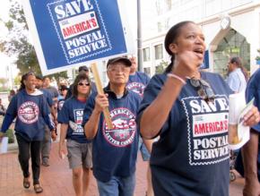 Postal workers demonstrate during a national day of action to defend their jobs