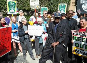 Activists in San Francisco deliver a foreclosure notice to Wells Fargo CEO John Stumpf