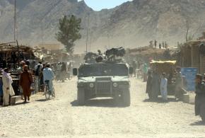 A U.S. convoy patrols a market in Kandahar province