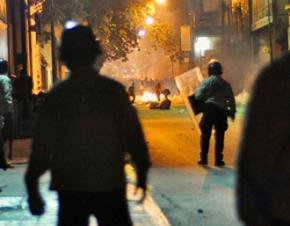 Police look on as right-wing protesters set a fire in a Caracas street