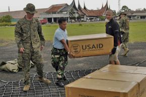 Workers in Indonesia unload relief supplies from USAID following a 2009 earthquake