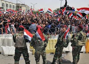 Masses of protesters confront Iraqi troops at the boundaries of the Green Zone in Baghdad