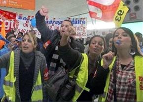 Striking French rail workers demonstrate inside a terminal