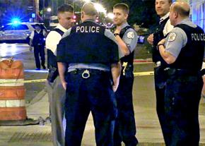 Chicago police huddle next to a crime scene