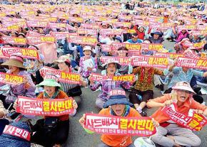 Protesters sit in against plans for a new missile defense system in South Korea