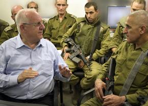 Israeli President Reuven Rivlin (left) talks with a group of military commanders near the Gaza border