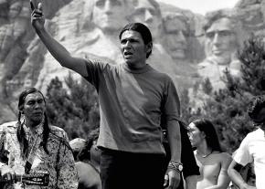 Dennis Banks leads a protest in front of Mount Rushmore