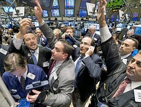 Wall Street traders jostle on the floor of the New York Stock Exchange