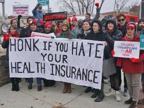 Single-payer activists rally outside a health insurance industry conference